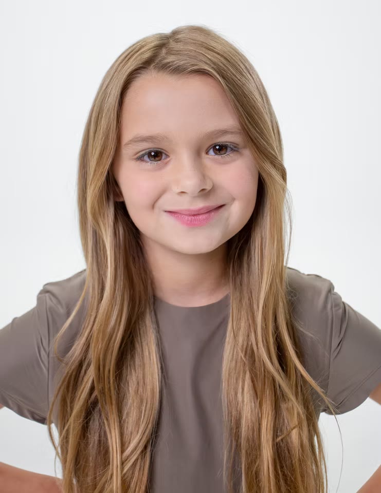 Young talent headshot on warm neutral backdrop