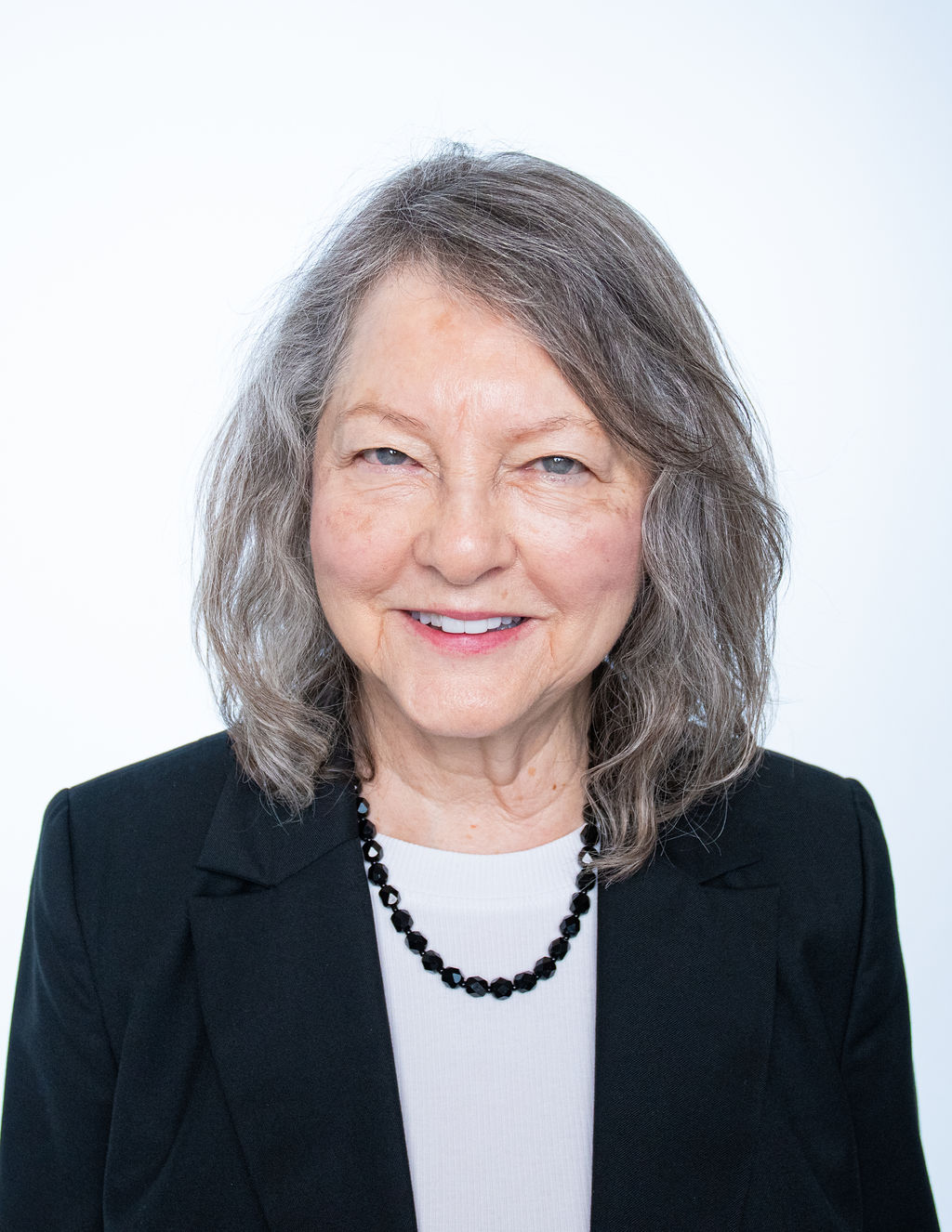 Melanie, professional headshot with pearl necklace