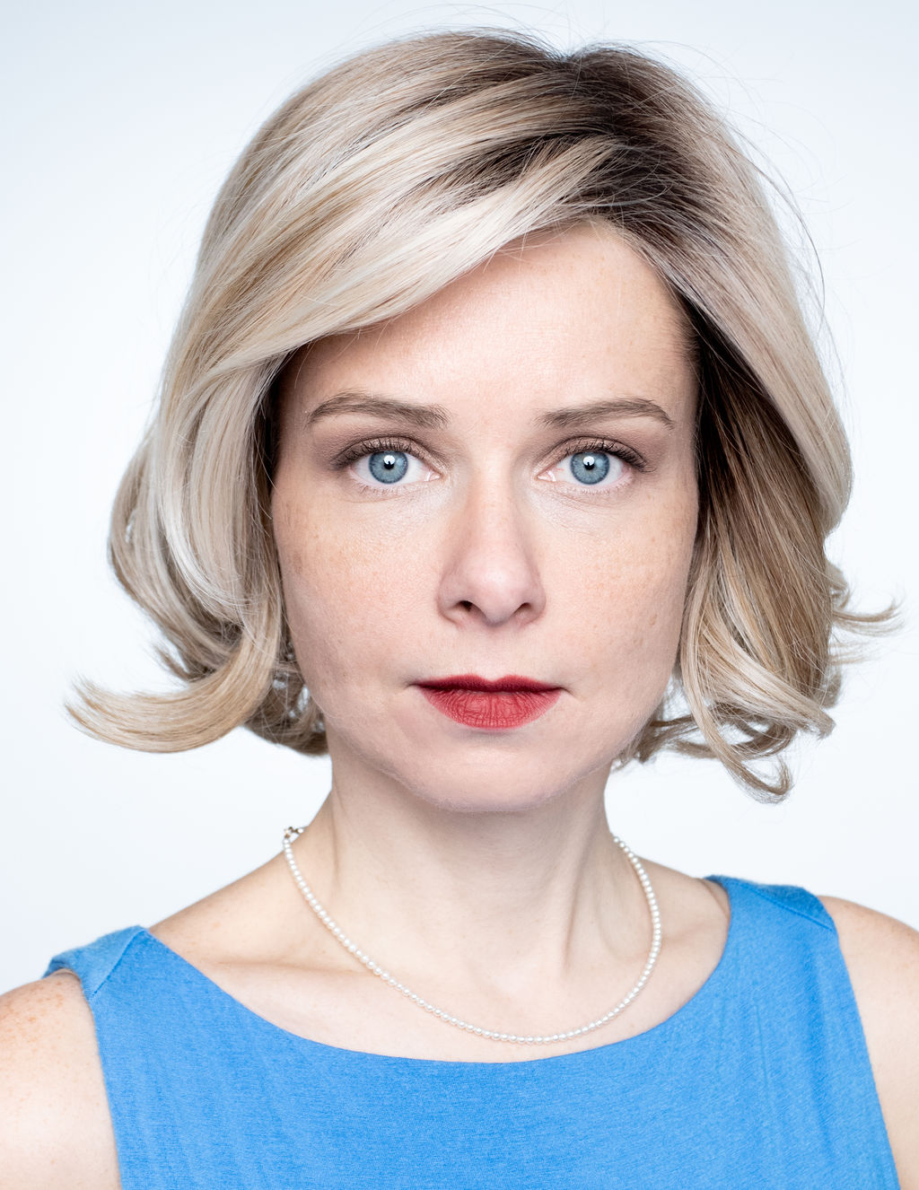Kelly, close crop headshot on soft grey