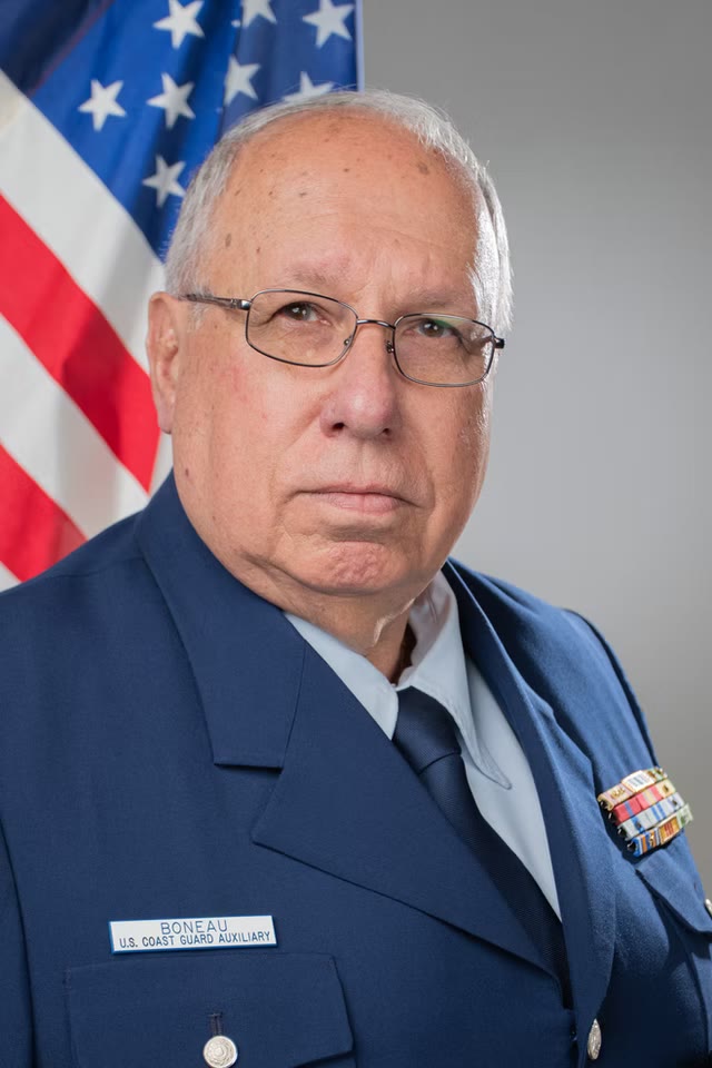 Service portrait in uniform with flag backdrop