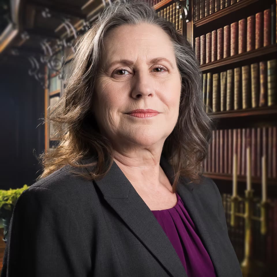 Environmental library portrait in charcoal blazer