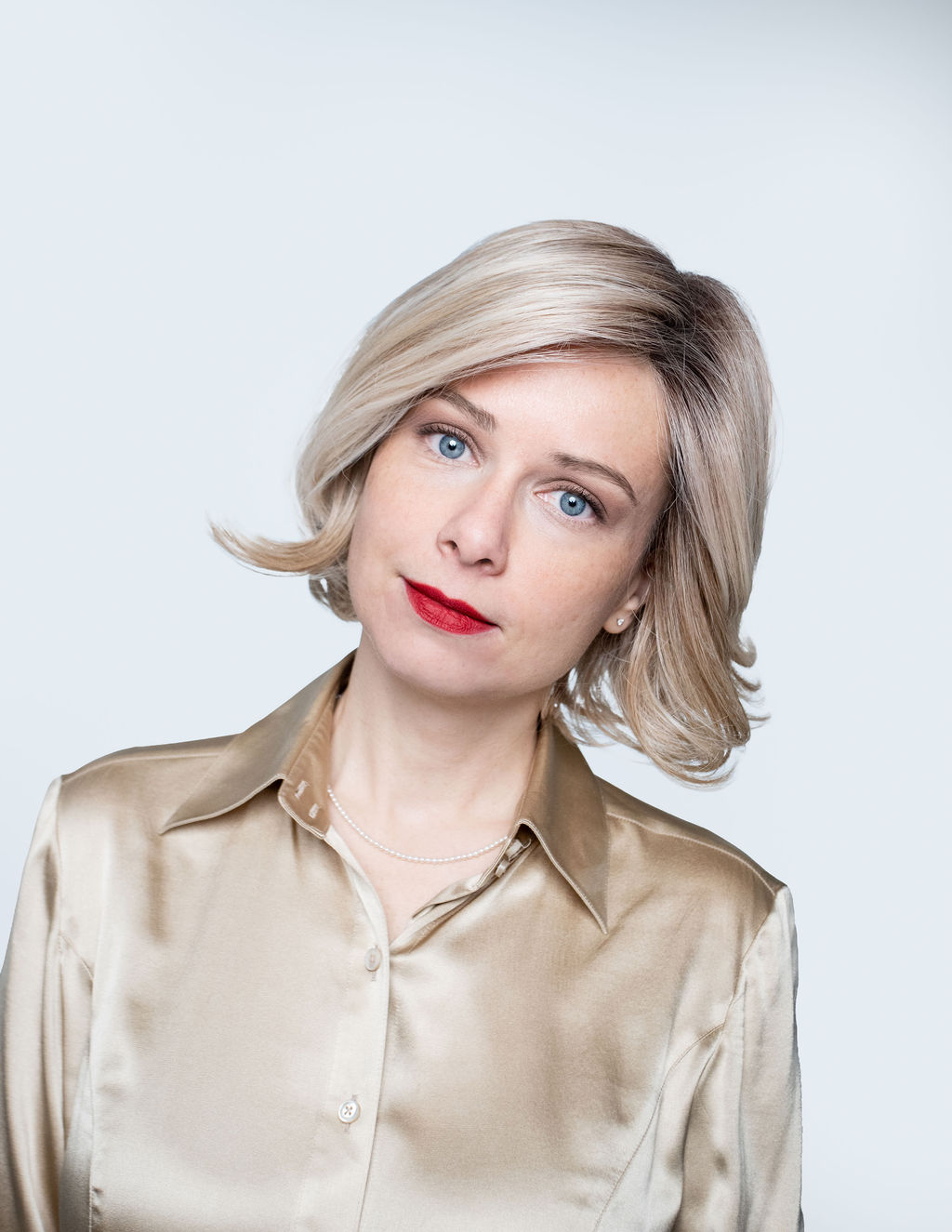 Kelly, high-key studio headshot in satin blouse
